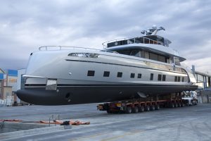 A superyacht being transported to the water