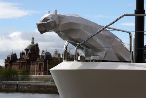 A metal stylised sculpture of a cat on board Lady M