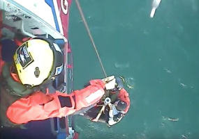 A surfer is airlifted to safety on board a Coastguard helicopter