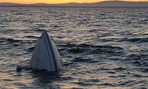 A speedboat sinking in a lake