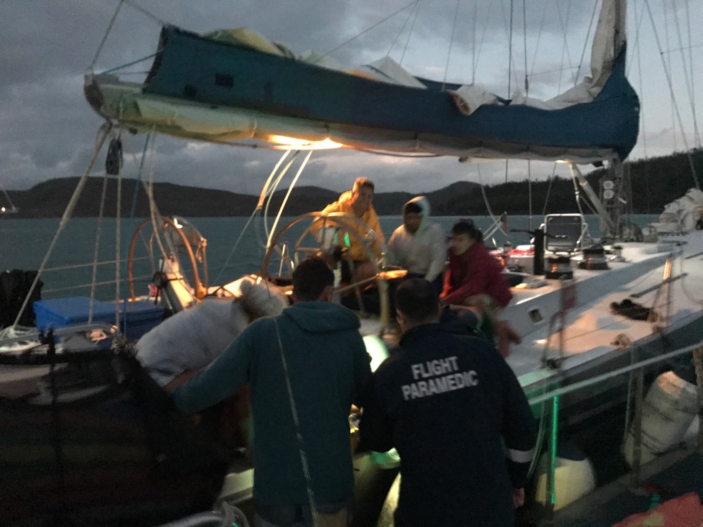 Paramedics on board a yacht in Queensland after a British tourist's leg is degloved in a yachting accident