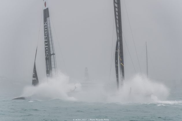 Two boats race each other with white spray