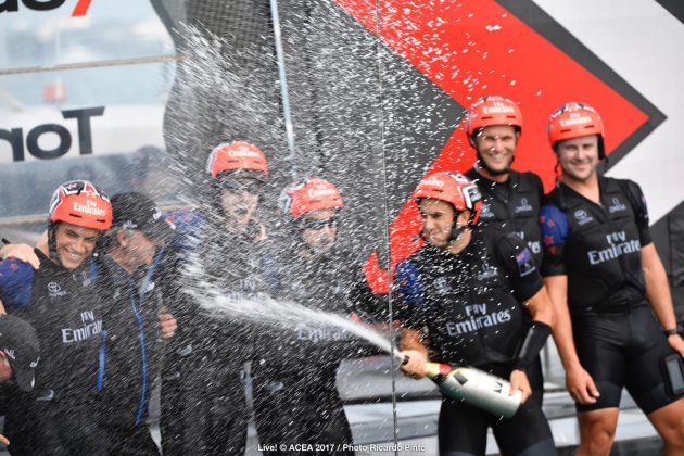 men spraying champagne