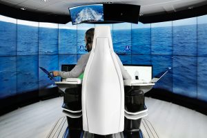 A man sits in a white chair to test the world's first autonomous vessel from Rolls-Royce