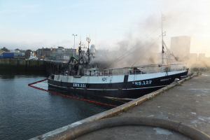 A fishing boat on fire