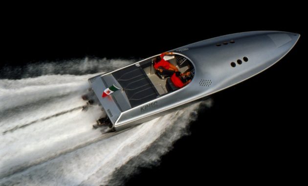 A silver powerboat at full throttle