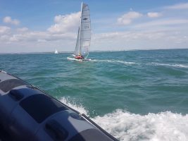 A catamaran with two people on board sailing close to No Man's Land Fort in the Solent