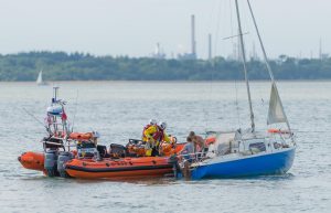 A yacht with two crew on board struggles in the Solent as the Cowes RNLI comes to assist