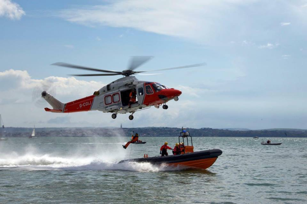 helicopter overing above boat on the sea