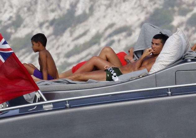 man lying on sunlounger on yacht