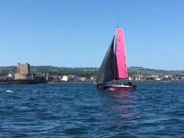 A yacht with pink sails is sailed by Natasha Lambert