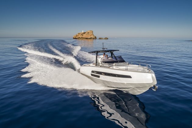 A motor yacht with a roof speeding through the sea