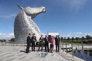 the queen standing by the Kelpies