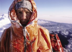 Dressed in an orange immersion suit, Pen Hadow prepares to trek from Canada to the North Pole