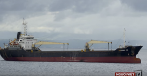 A red and black cargo ship in the southern Philippines