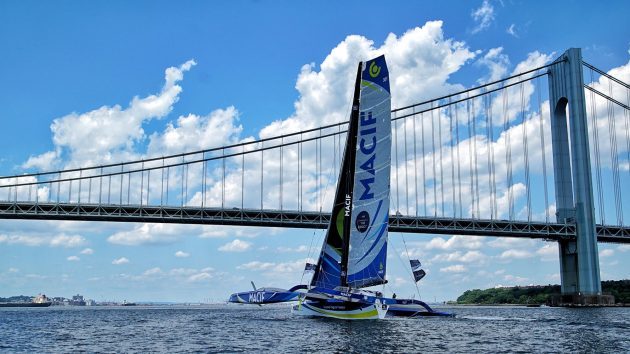 A maxi trimaran with a blue and white sail in New York