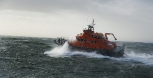 The orange all-weather Rosslare Harbour RNLI lifeboat leaving on a shout