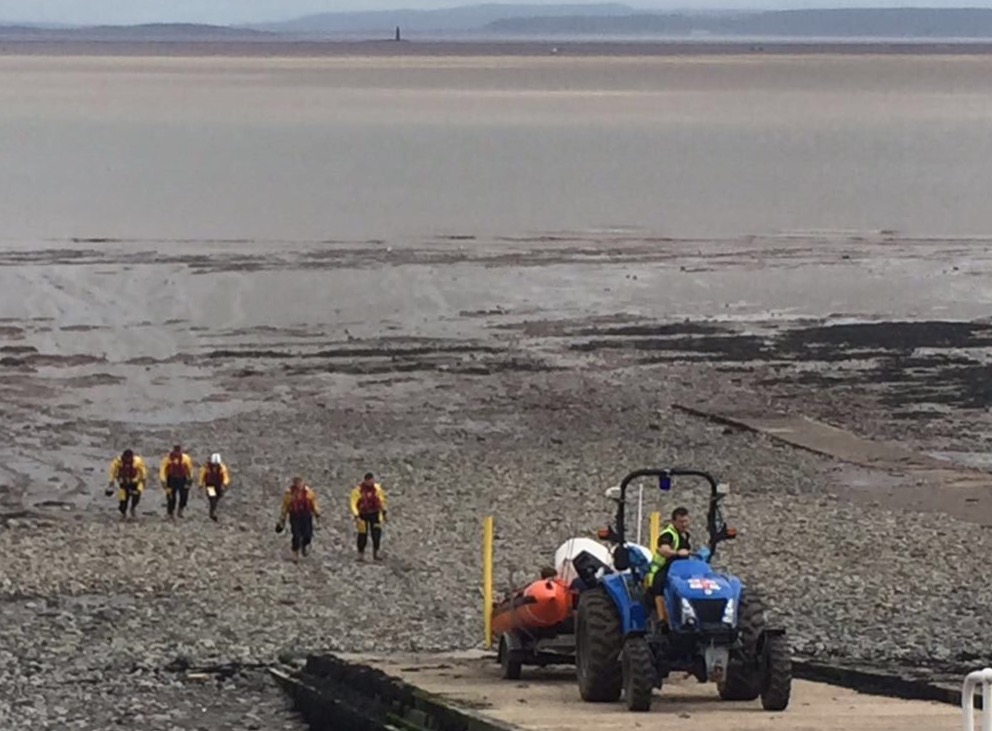 men and truck on the beach