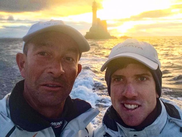 Dressed in caps, Peter Burling and Ian Budgen grab a selfie at the Fastnet Rock