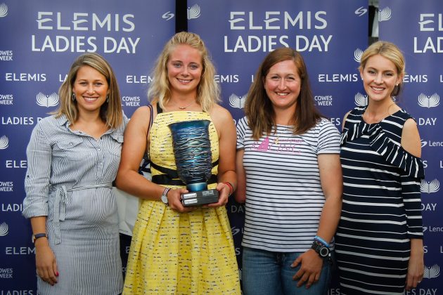 four women posing with a trophy