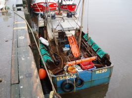 A fishing boat moored alongside a quay