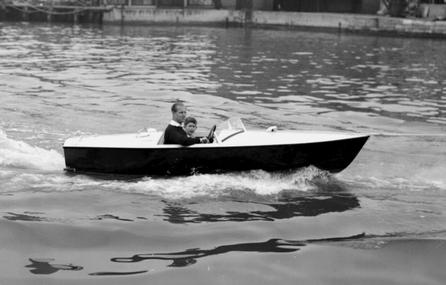 Prince Philip and Prince Charles on a motor boat