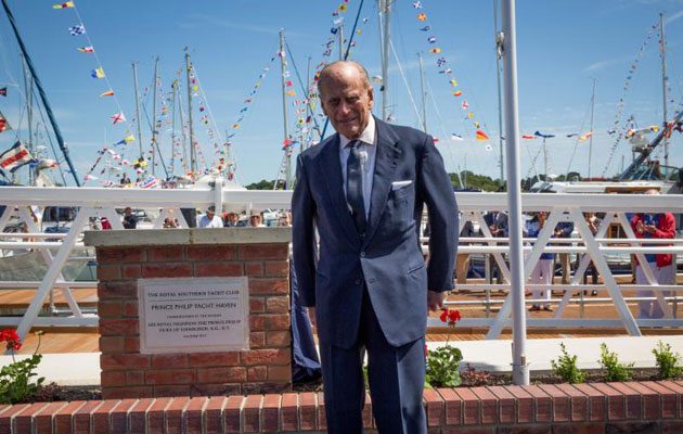 Prince Philip unveils a plaque at a marina