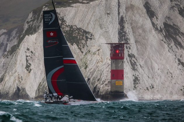 yacht sailing by a cliff