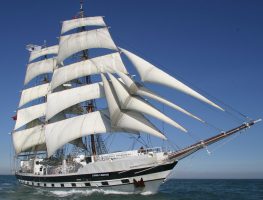 The tall ship- Stavros S Niarchos with white sails on the water