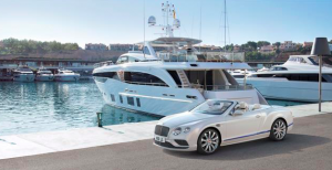 car and yacht next to each other