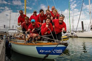 Crew wearing red on board a yacht which was named the overall winner of Cowes Week 2017