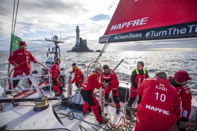 Dressed in red, a crew on a Volvo Ocean Race boat takes part in the Fastnet Race