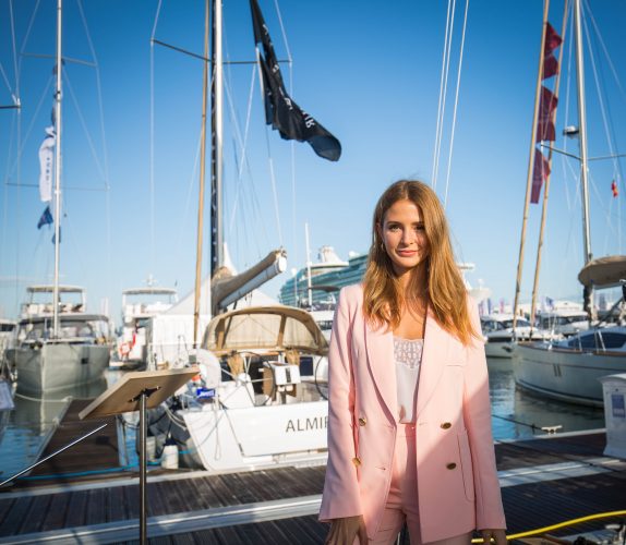 Millie Mackintosh dressed in pink standing on a pontoon
