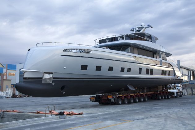 A superyacht is transported for launch