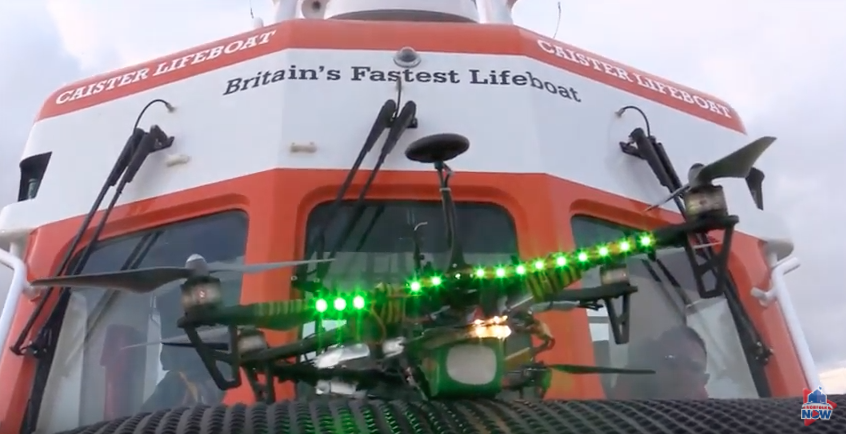 A drone with lights on the front of an offshore Caister lifeboat