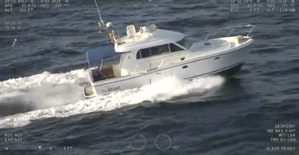 A white motor boat being driven through the water