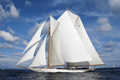 A superyacht with white sails