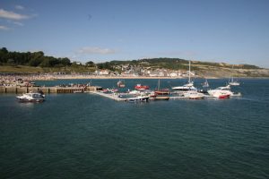 Yachts and boats moored at the harbour at Lyme Regis