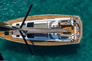 A woman sunbathes on the deck of a Dufour yacht