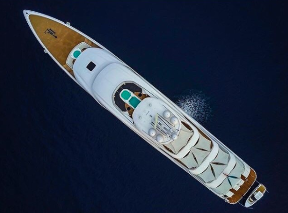 An aerial view of a white and wooden superyacht