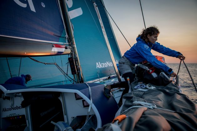 A woman sailor sorts out gear on board a Volvo Ocean Race yacht