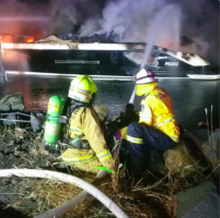 firemen tending to boat fire