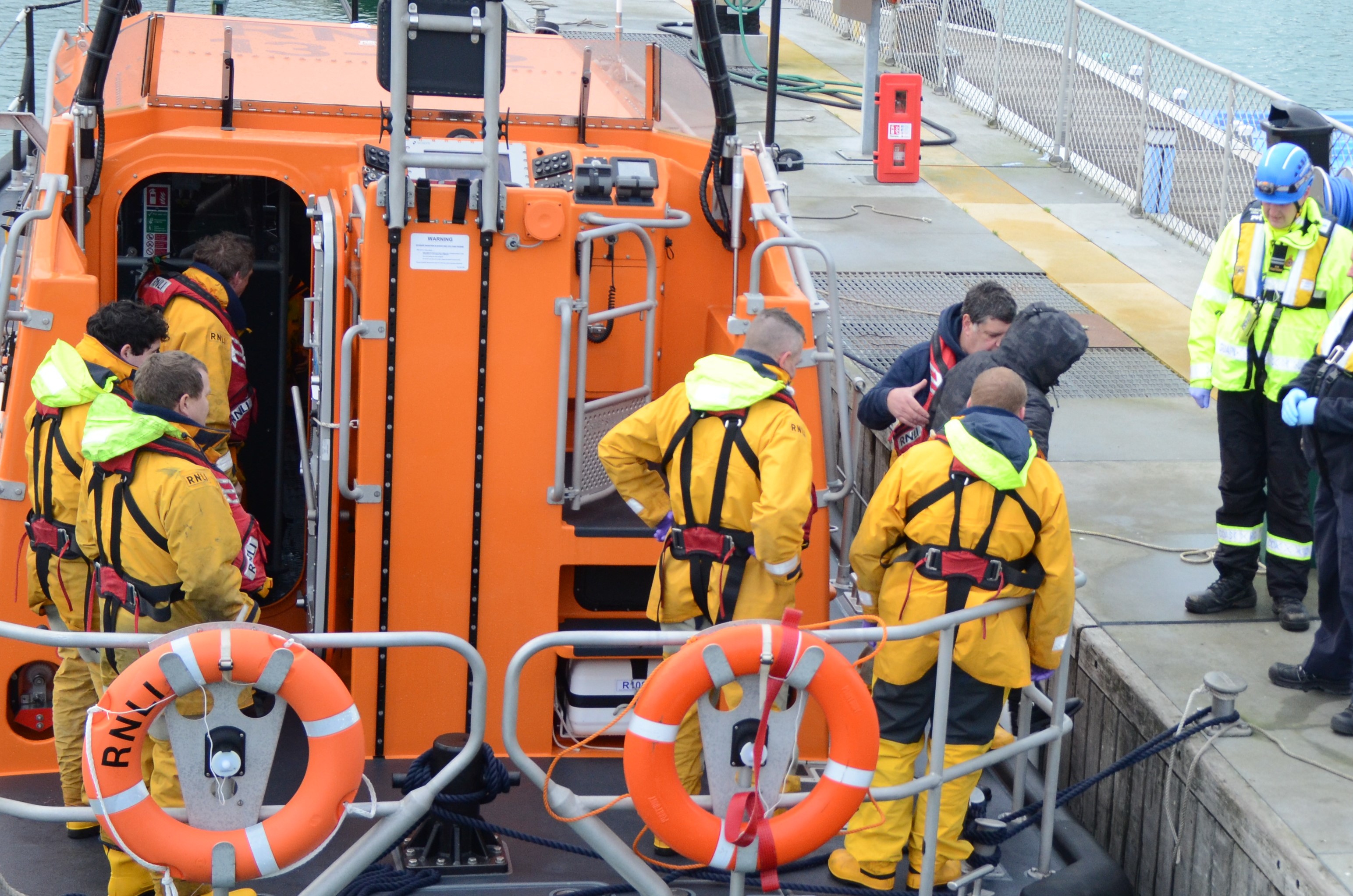 Casualties being escorted from Dungeness lifeboat Credit:  RNLI/Bob Jeffery