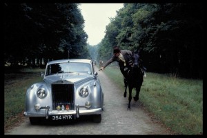 Bond in Motion. Rolls Royce Silver Cloud with Bond (Roger Moore) attempting to escape by leaping into the car from his horse