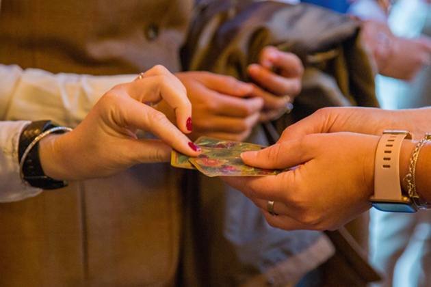 well-manicured, female hands picking pegs