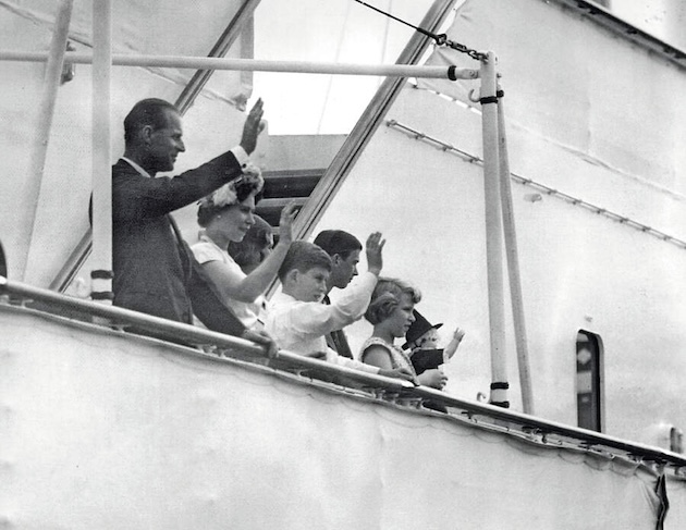 Prince Philip, the late Queen, the then Prince of Wales and Princess Anne wave to the crowds as they sail from Cardiff
