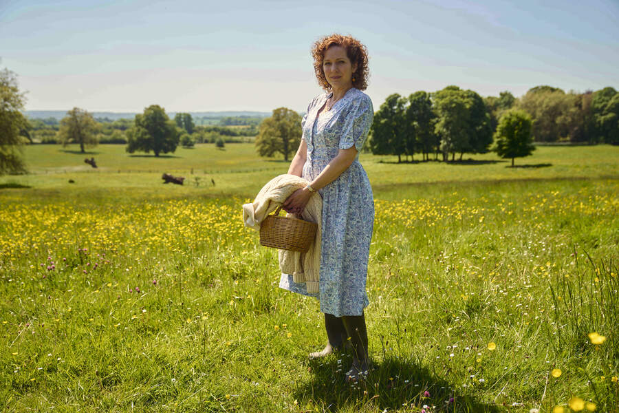 woman in field in summer dress