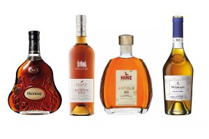 Four XO Cognac bottles: Hennessy, Frapin, Hine, Delamain