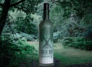 A bottle of gin superimposed on a woodland scene