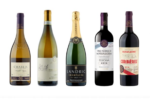 Five bottles of wine against a white background